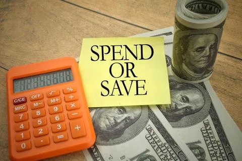 Selective focus image of calculator and bank note with SPEND OR SAVE wording  Stock Photos