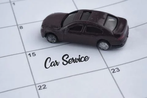 Selective focus image of car miniature on a calendar with Car Service wording Stock Photos
