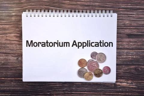 Selective focus image of coin with Moratorium Application wording and wooden  Stock Photos