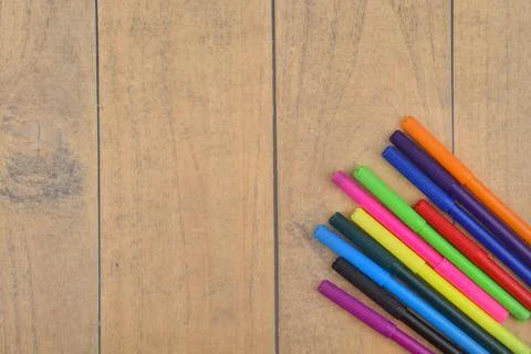 Selective focus image of colorful pen on a wooden background with copy space Stock Photos