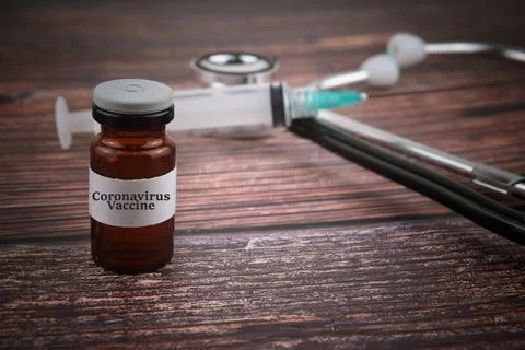 Selective focus image of coronavirus vaccine on blur background of stethoscop Stock Photos