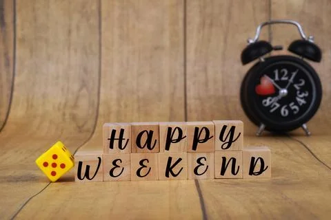 Selective focus image of Happy Weekend on a blur background of alarm clock . Stock Photos