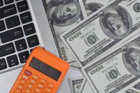 Selective focus image of laptop and calculator with usd bank note. Business a Stock Photos