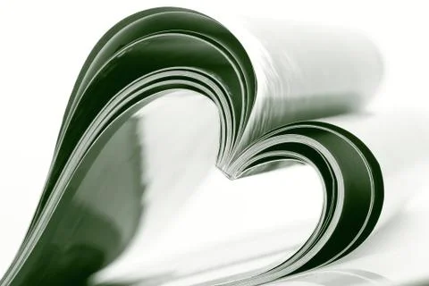 Selective focus image of magazine folded into a heart shape Stock Photos
