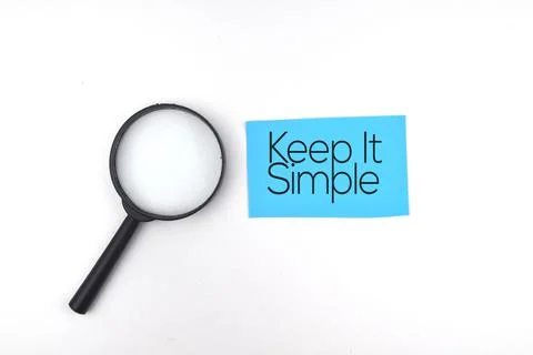 Selective focus image of magnifying glass with Keep It Simple wording on a wh Stock Photos