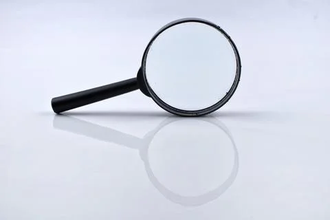 Selective focus image of magnifying glass isolated on a white background Stock Photos