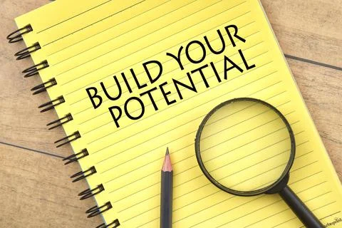 Selective focus image of magnifying glass and pencil with BUILD YOUR POTENTIA Stock Photos