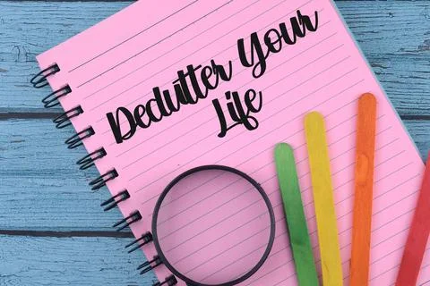 Selective focus image of magnifying glass and colorful stick with declutter y Stock Photos