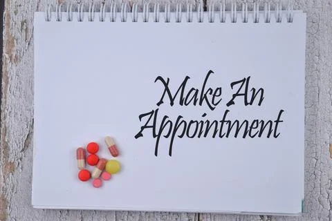 Selective focus image of medicine with Make An Appointment wording on a woode Stock Photos