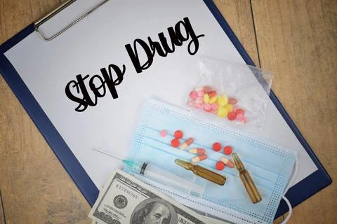 Selective focus image of medicine, syringe, face mask and bank note with Stop Stock Photos