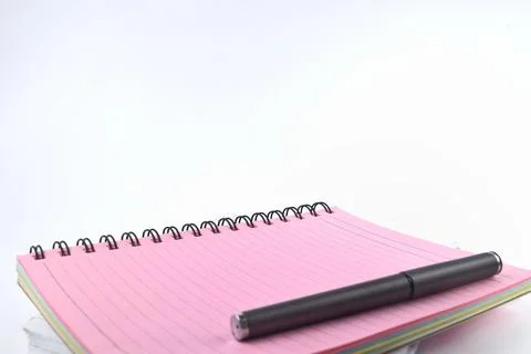 Selective focus image of notebook and pen isolated on a white background. Con Stock Photos