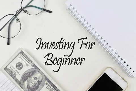 Selective focus image of notebook,bank note,spectacles and phone with Investi Stock Photos