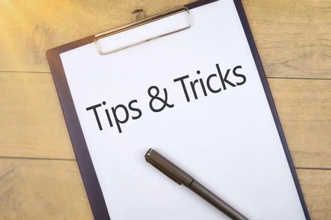 Selective focus image of pen and file holder on wooden background with Tips n Stock Photos