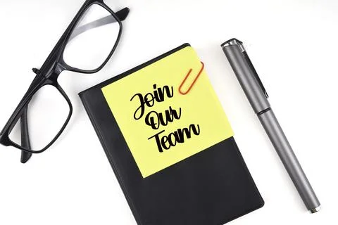 Selective focus image of pen, spectacles and sticky note with join our team w Stock Photos