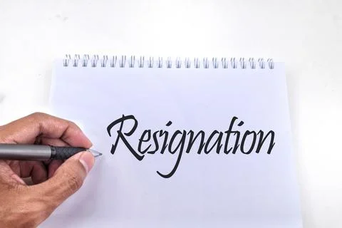 Selective focus image of a person hand holding pen with Resignation wording.  Stock Photos