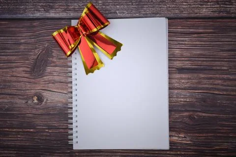 Selective focus image of red shiny ribbon with copy space on a wooden backgro Stock Photos