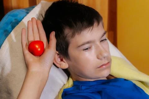 A selective-focus image showing a boy reclining on a pillow. Foto stock
