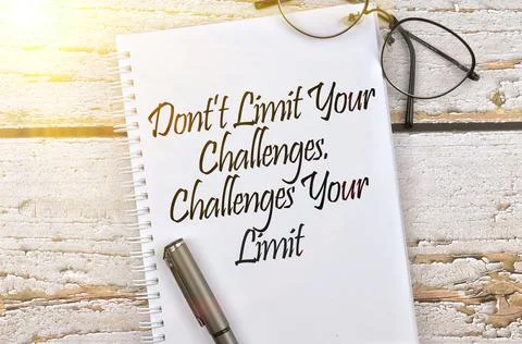 Selective focus image of spectacles and pen with Don't Limit Your Challenges, Stock Photos