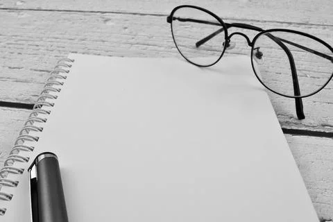 Selective focus image of spectacles and pen with copy space. Stock Photos