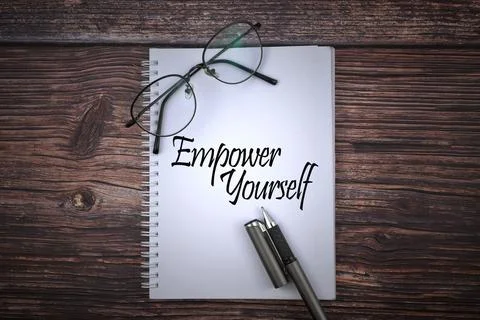 Selective focus image of spectacles and pen with Empower Yourself wording on  Stock Photos