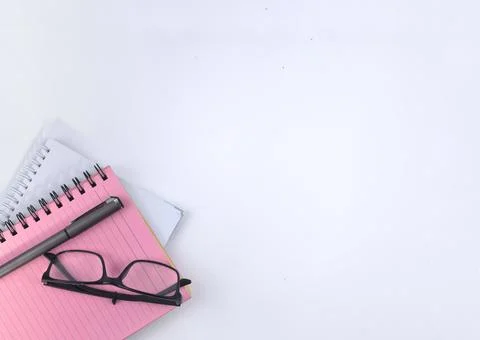 Selective focus image of spectacles and notebook on a white background with c Stock Photos