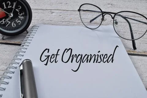 Selective focus image of spectacles,pen and clock with Get Organised wording  Stock Photos