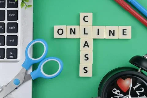 Selective focus image of stationary kits with online class wording on green b Stock Photos