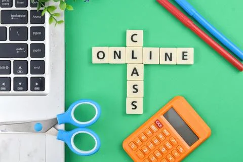 Selective focus image of stationary kits with online class wording on green b Stock Photos