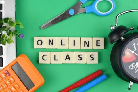 Selective focus image of stationary kits with online class wording on green b Stock Photos