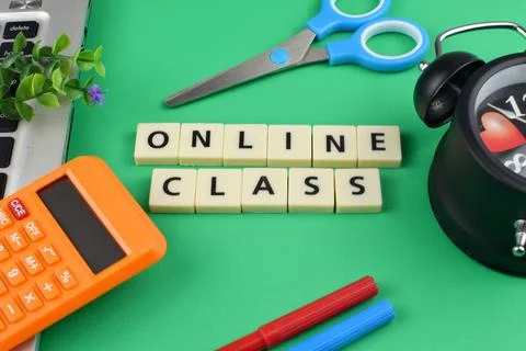 Selective focus image of stationary kits with online class wording on green b Stock Photos