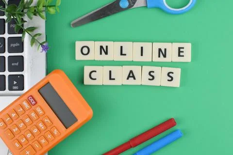 Selective focus image of stationary kits with online class wording on green b Stock Photos