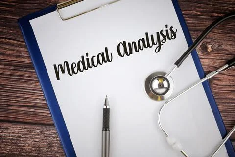 Selective focus image of stethoscope and pen with Medical Analysis wording on Stock Photos
