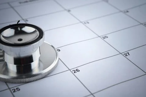 Selective focus image of stethoscope on a calendar with blur background. Conc Stock Photos
