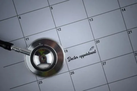Selective focus image of stethoscope on a calendar with Doctor Appointment wo Stock Photos