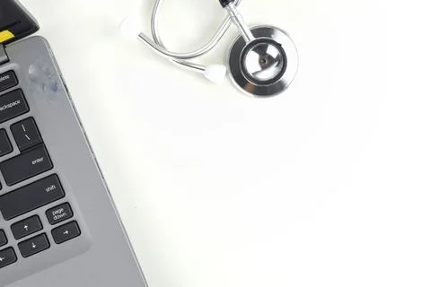 Selective focus image of stethoscope with laptop on a white background with c Stock Photos
