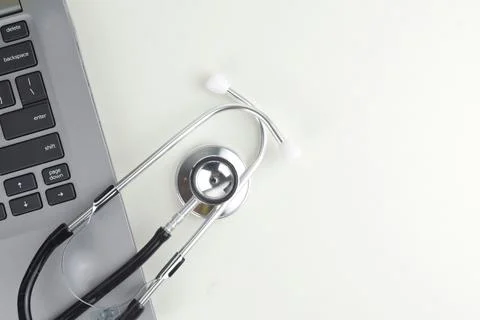 Selective focus image of stethoscope with laptop on a white background with c Stock Photos