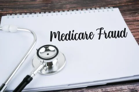 Selective focus image of stethoscope with Medical Fraud wording on a wooden b Stock Photos