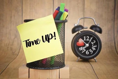 Selective focus image of Time Up wording on a blur background of alarm clock Stock Photos