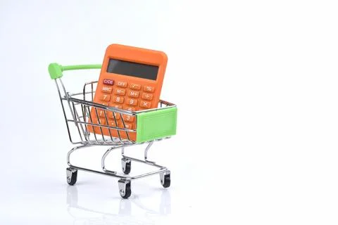 Selective focus image of trolley cart with calculator isolated in white backg Stock Photos
