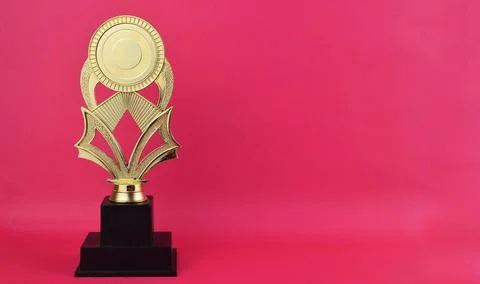 Selective focus image of trophy on pink background Stock Photos