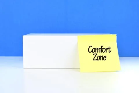 Selective focus image of yellow sticky note with Comfort Zone wording on a bl Stock Photos