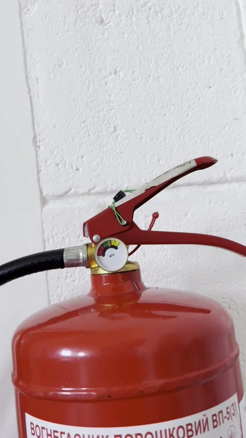 Selective focus on intact safety seal securing fire extinguisher Stock Footage 313713910
