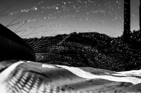 Selective focus on jets of droplets shooting out across a water slide Stock Photos