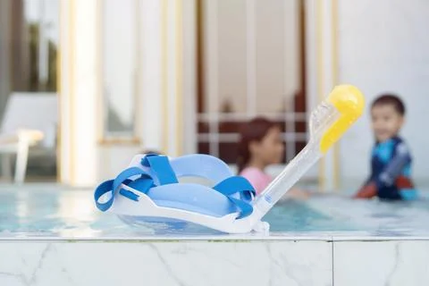 Selective focus of kid diving goggles and blurred behind of happy children .. Stock Photos