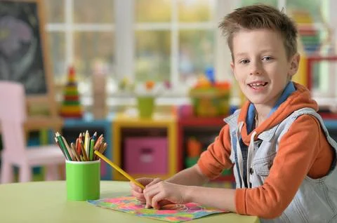 Selective focus of kid drawing at desk Stock Photos