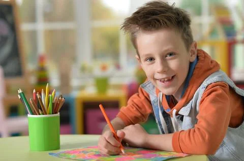 Selective focus of kid drawing at desk Stock Photos