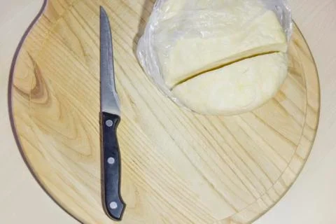 Selective focus knife and dough on the chopping board Stock Photos