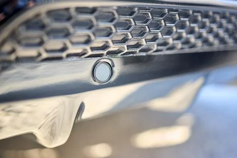 Selective focus on left side of rear bumper parking sensor at back of luxurious Stock Photos