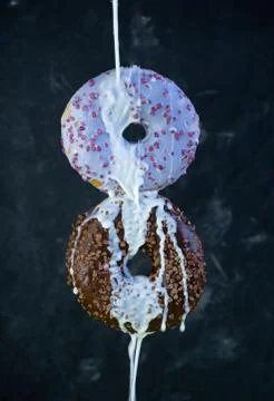 Selective focus, levitating sweet doughnuts with chocolate and blueberry icin Stock Photos
