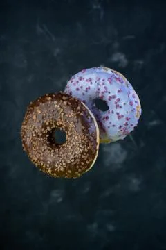 Selective focus, levitating sweet doughnuts with chocolate and blueberry Stock Photos